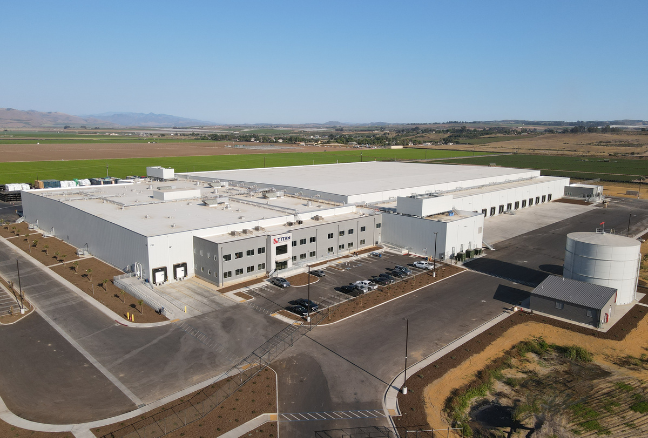 An aerial view of a large warehouse with lots of windows.
